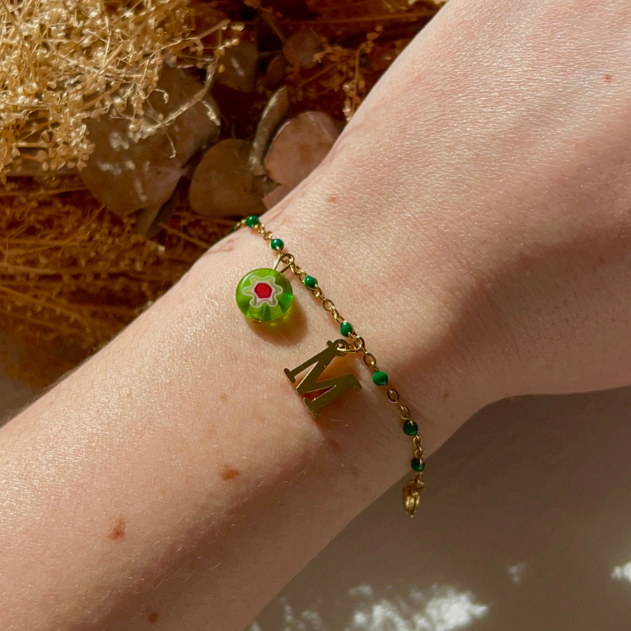bracelet maddy personnalisable avec lettre et perle Millefiori, présenté ici avec la lettre M et perle verte 